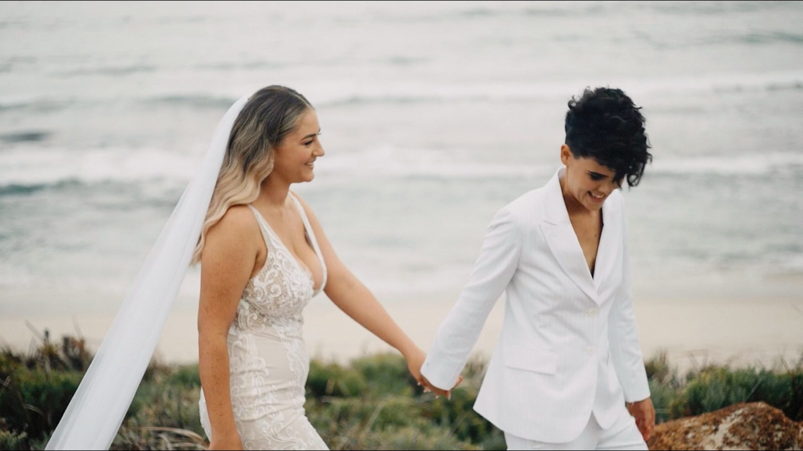 Bride and bride walking along the beach during their Parry Beach Breaks wedding in Denmark WA