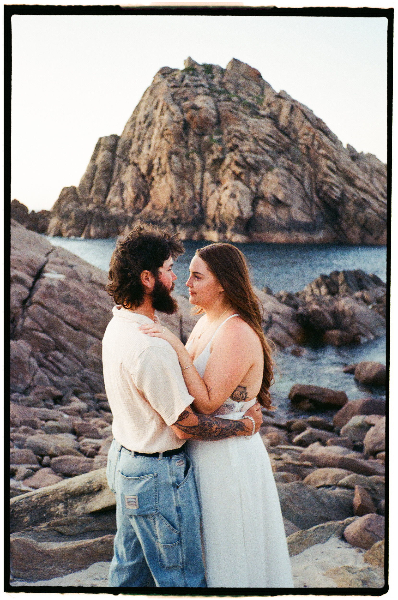 Cinematic film engagement photograph at Sugarloaf Rock in Dunsborough